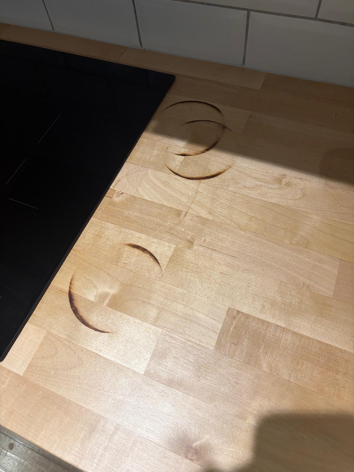 Wooden worktop scorch marks — before repair